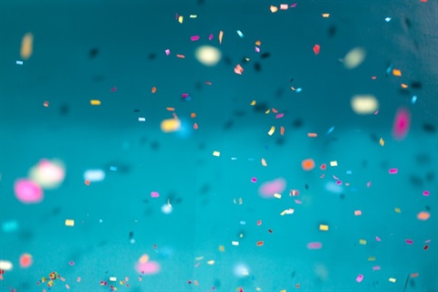 confetti falling against blue backdrop