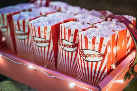 tray full of bags of popcorn