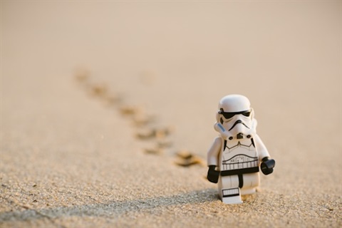 lego stormtrorper walking on a beach